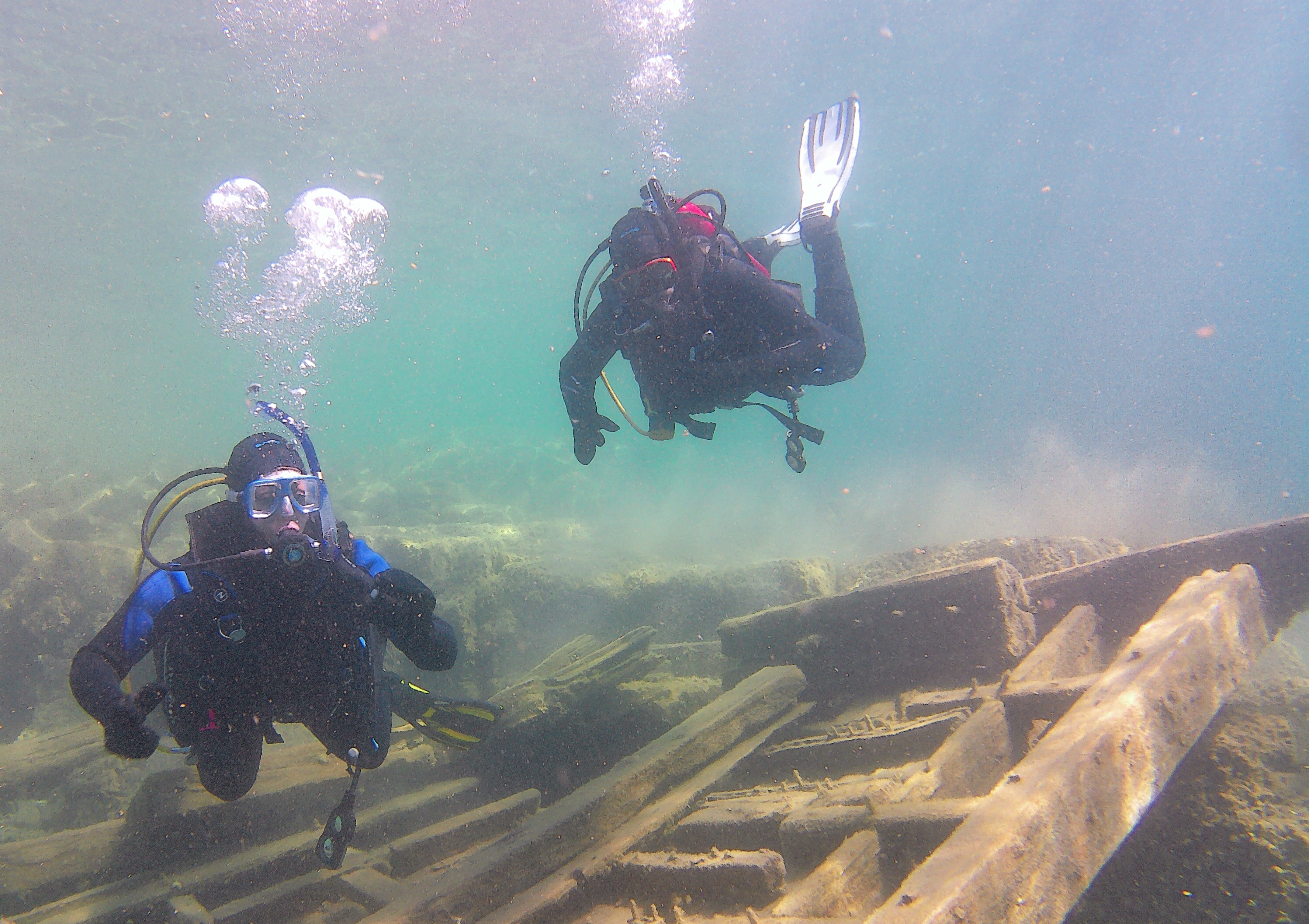 divers on shipwreck