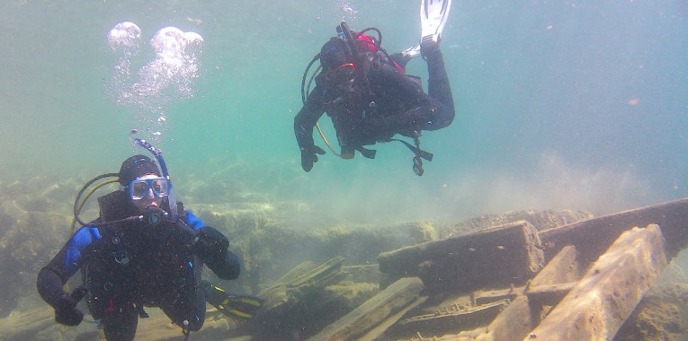 divers on shipwreck