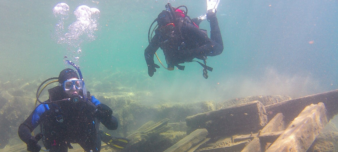 divers on shipwreck